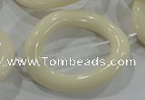 CTU1867 15.5 inches 32*40mm twisted oval donut synthetic turquoise beads