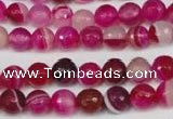 CAG2085 15.5 inches 6mm faceted round fuchsia line agate beads